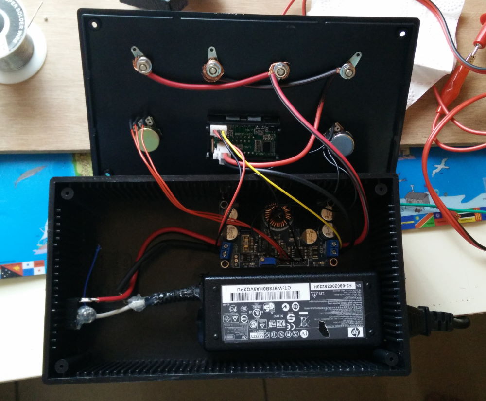 Photo of the insides of the power supply, showing the buck-boost converter and the laptop power supply
